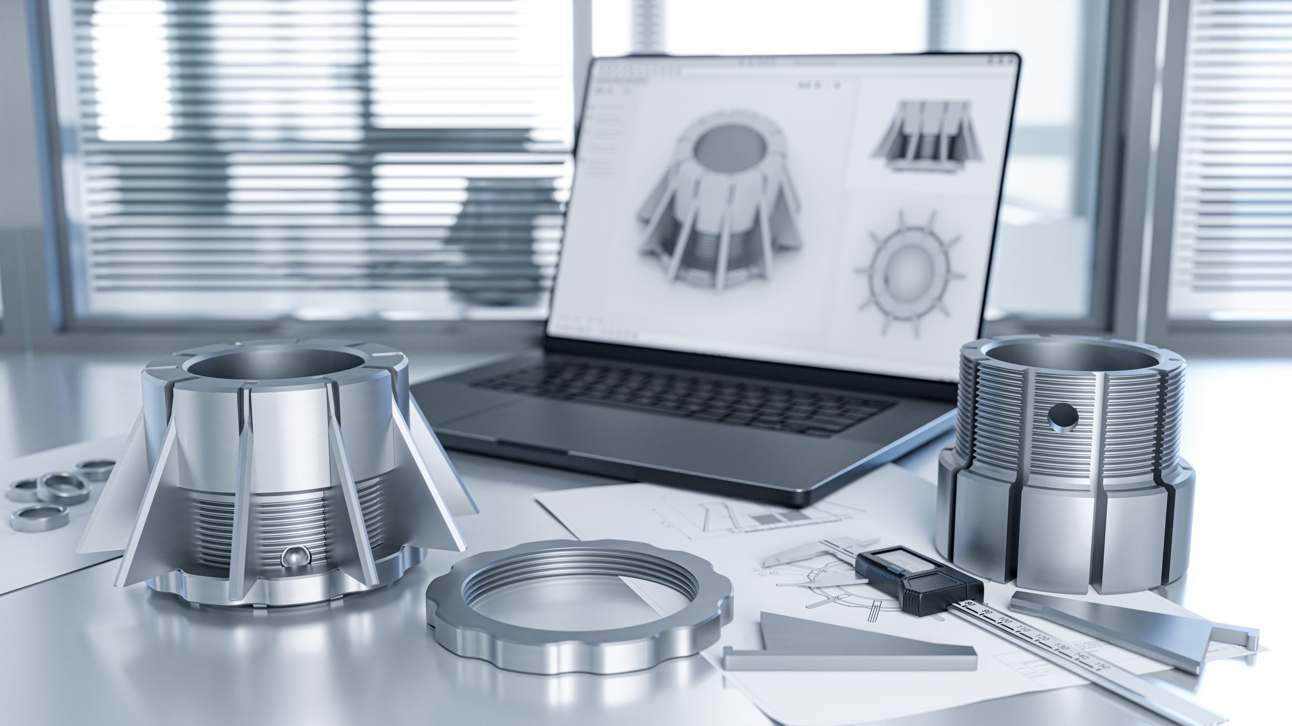 Engineer’s desk while testing the quality of thread and fit mechanical components, using a caliper and a laptop with a CAD program